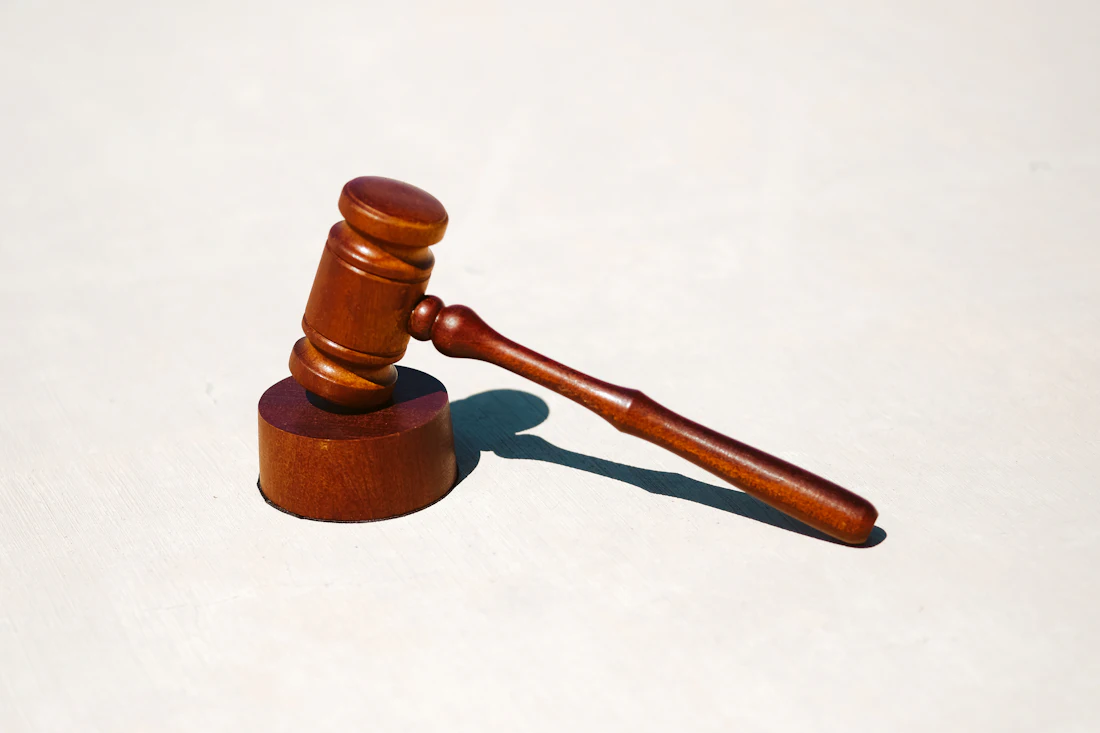 A wooden gavel resting on its block.